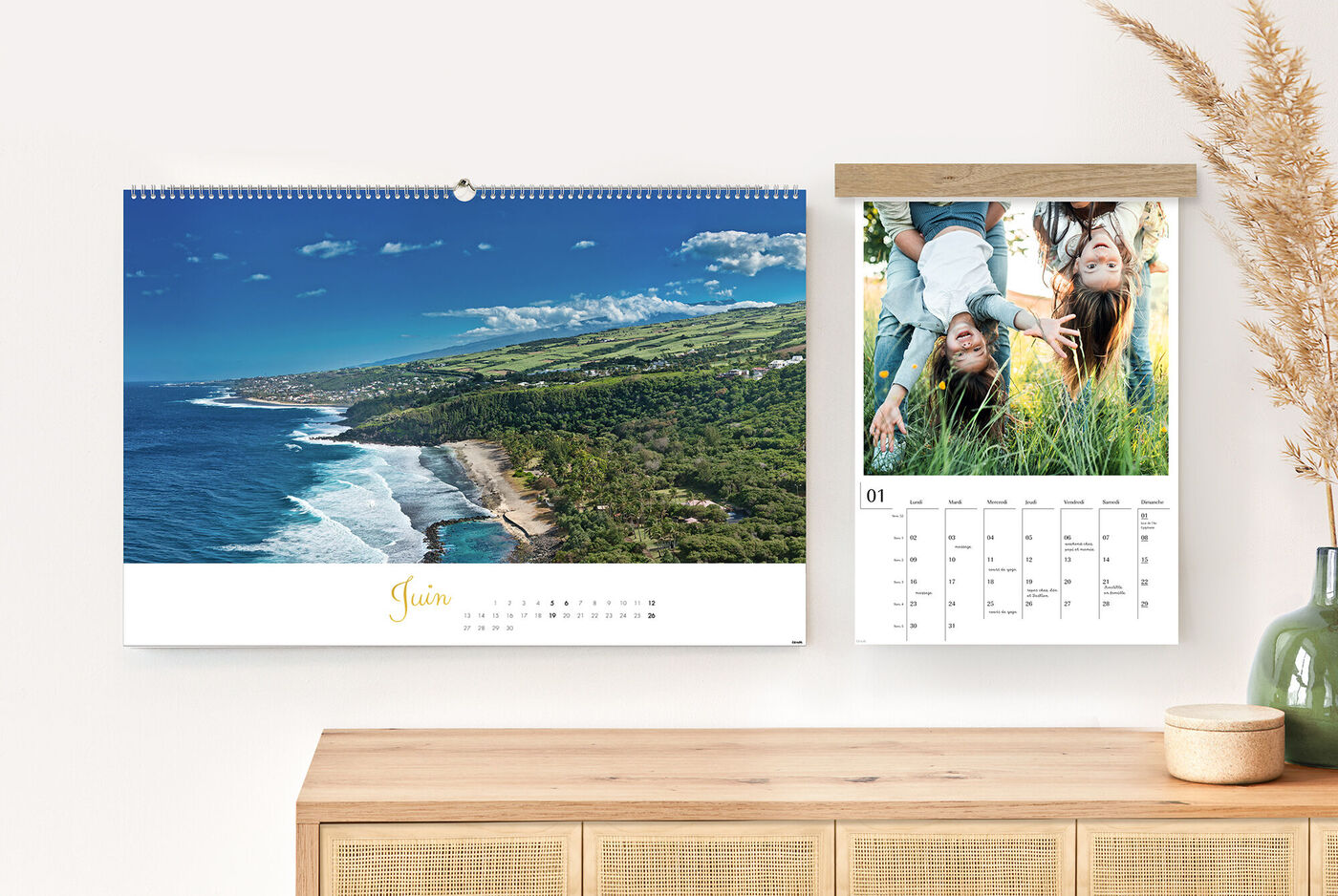 Un grand calendrier photo en format paysage et un calendrier photo portrait accroché au mur au-dessus d'une commode