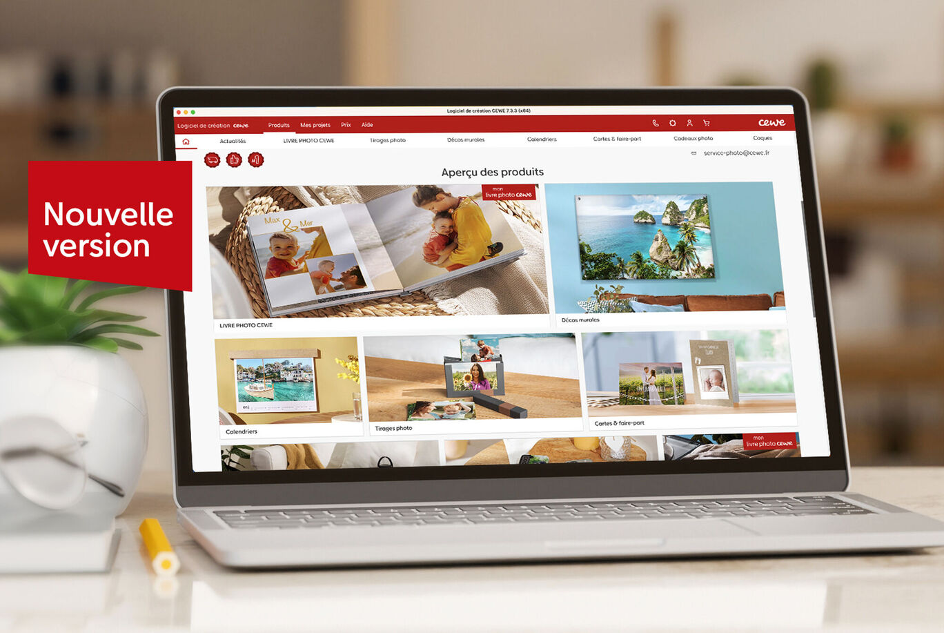 Un ordinateur portable affichant la nouvelle version du site CEWE avec des produits photo colorés et des photos de famille.