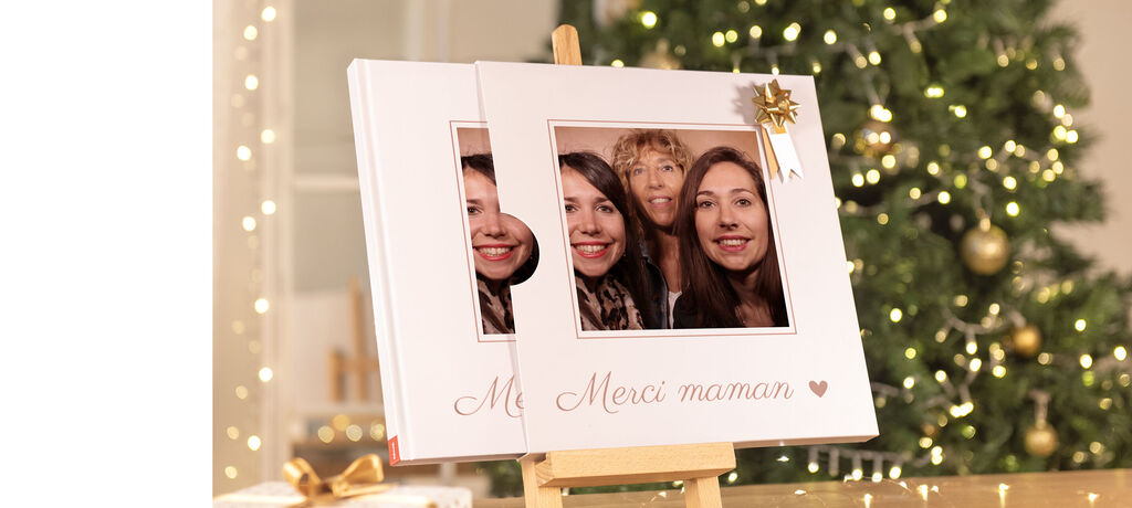 Un magnifique livre photo est sur une table, entouré de lumières dorées. Idéal comme cadeau.