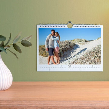 Un calendrier photo fait main montre un couple heureux sur la plage.