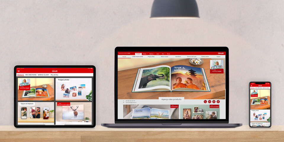 Vue du site CEWE sur un ordinateur, une tablette et un smartphone, montre un livre photo avec des images de paysages et d'enfants souriants.