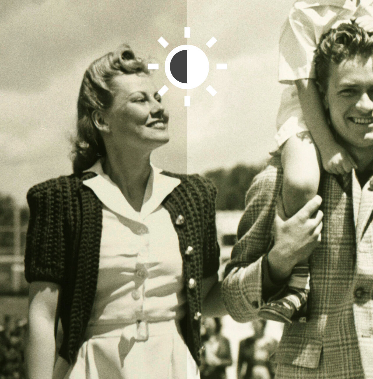 Un couple profite d'une journée ensoleillée, pendant qu'un enfant est sur les épaules de l'homme.