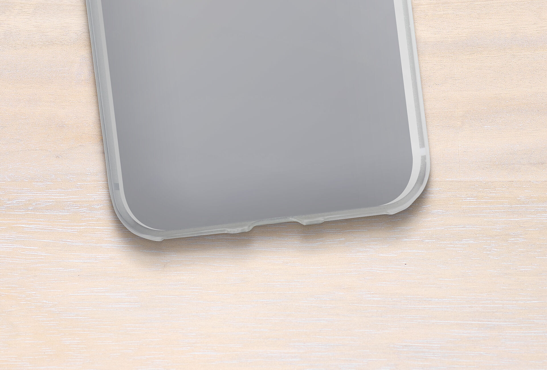 Vue de l'angle d'un smartphone sur une surface en bois clair