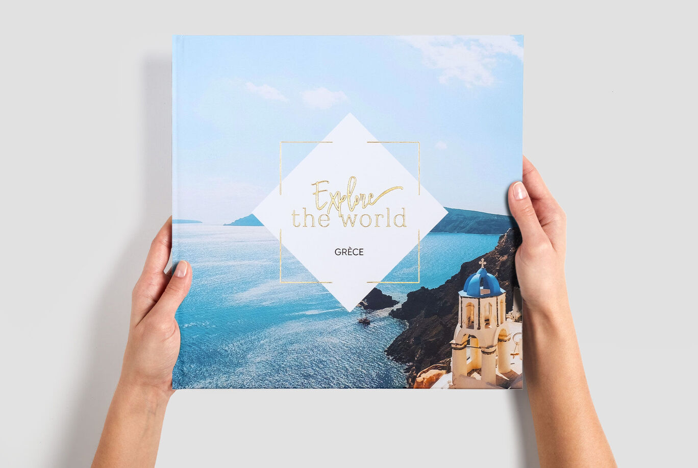 Grand album photo carré de vacances en Grèce, tenu entre 2 mains