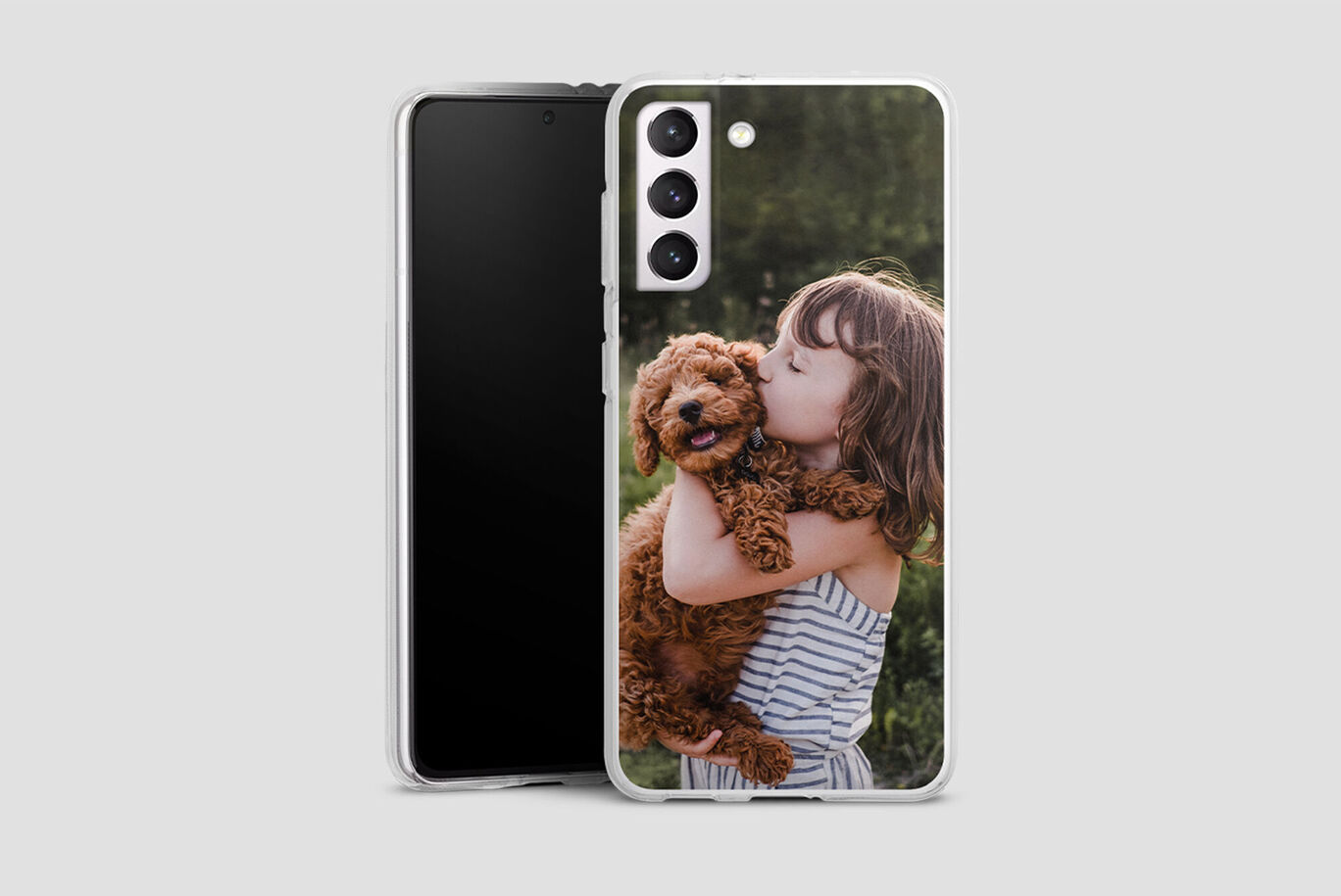 Une fille tient un chien brun dans les bras et sourit joyeusement.