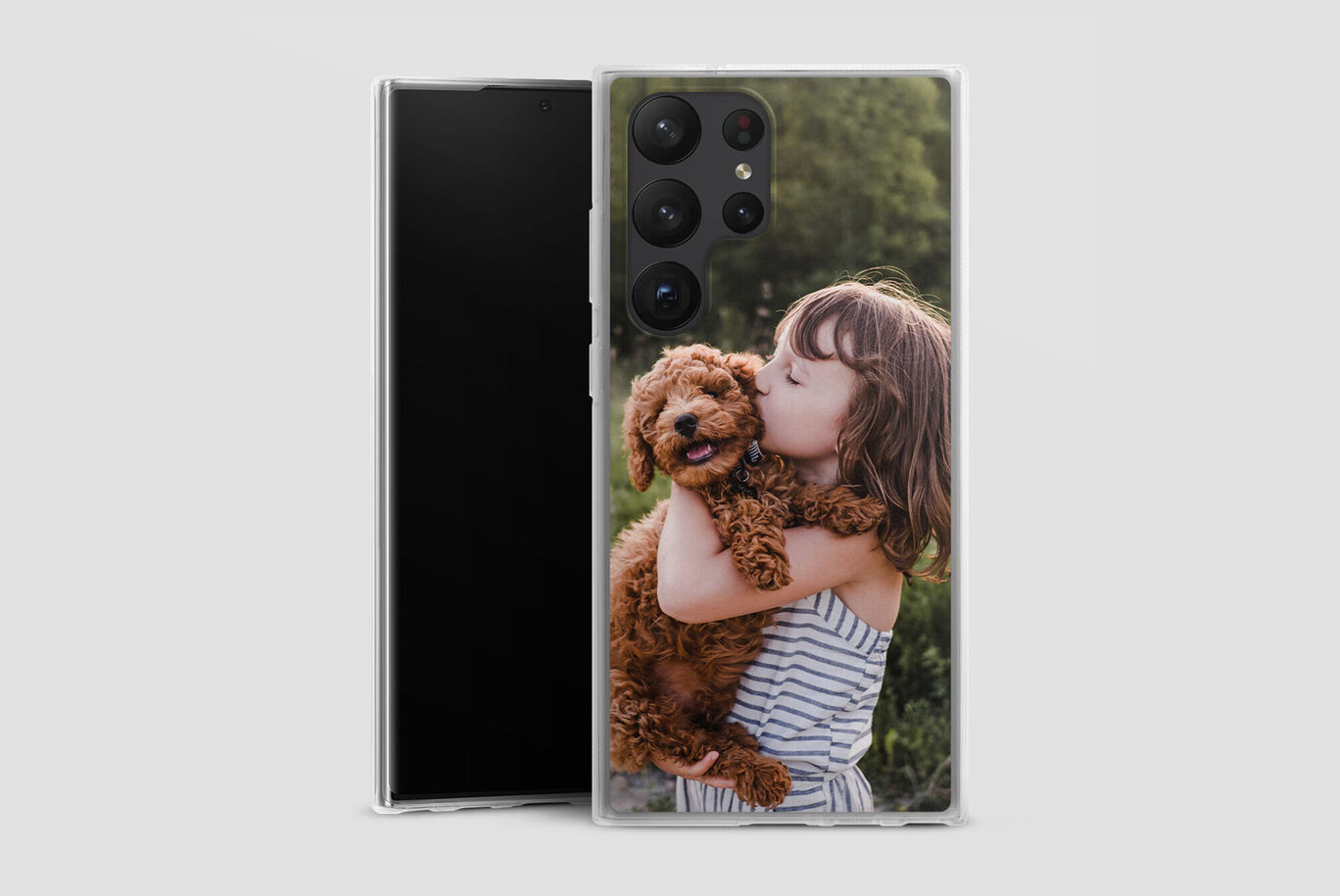 Un enfant tient un petit chien dans ses bras et sourit joyeusement.